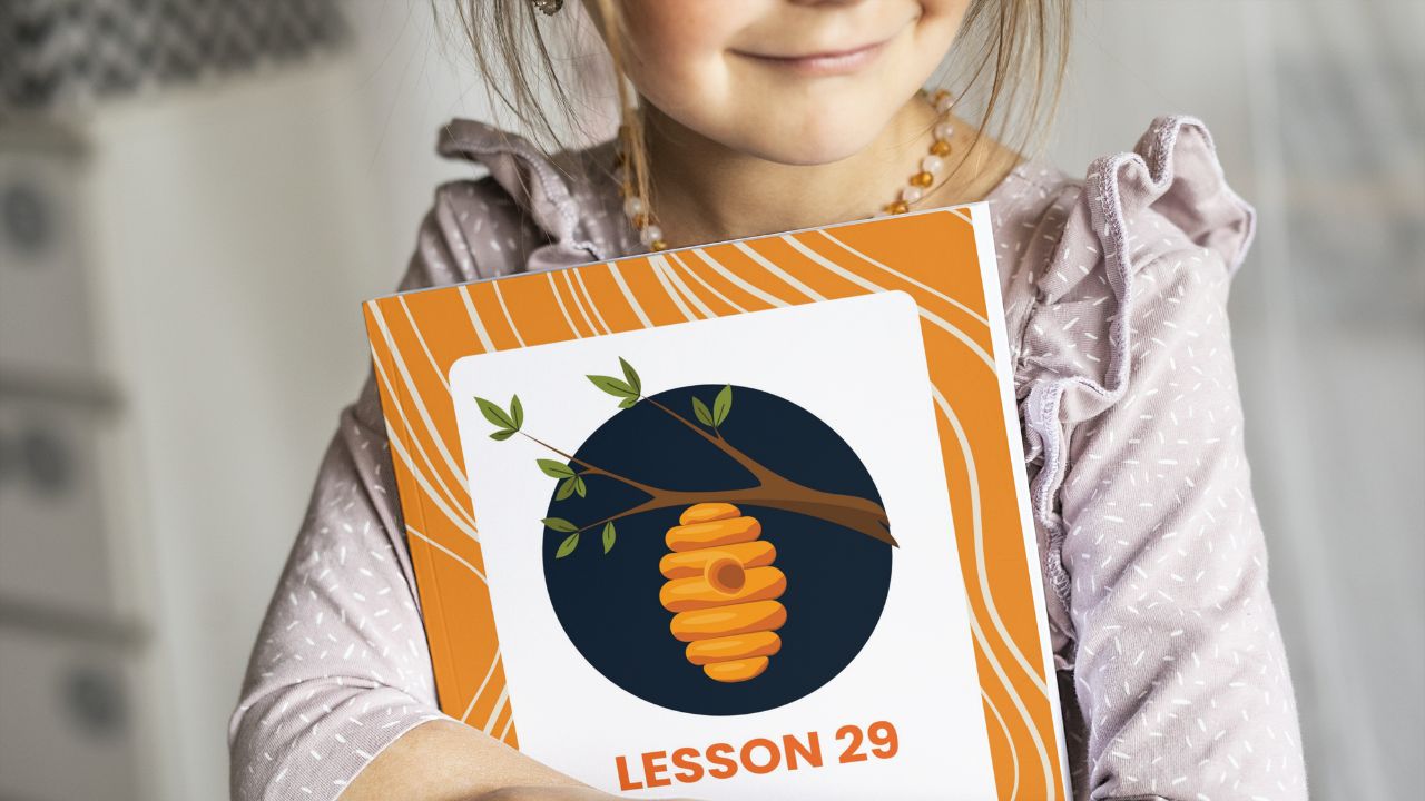 Child holding Apricot Tree Academy lesson book